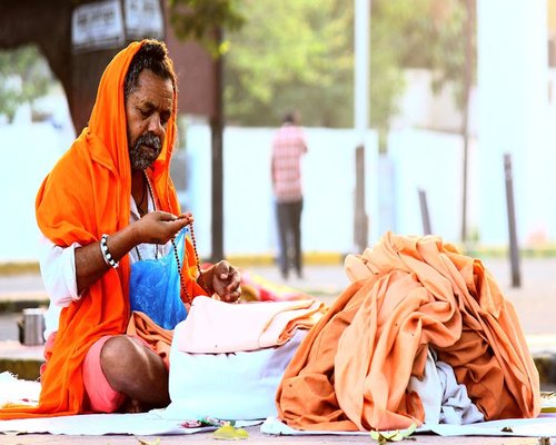 Indian man meditating in nature sunlight
