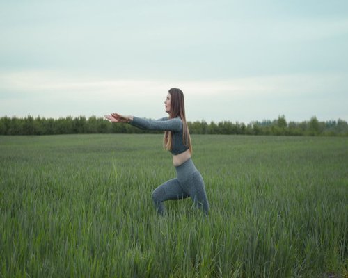 Active healthy indian woman stretching outdoors