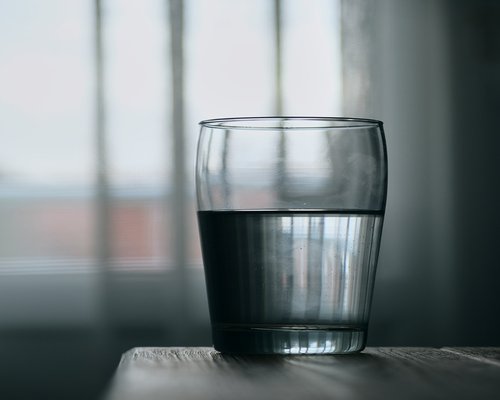 Person drinking water from glass